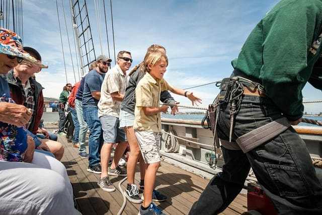 Guests jump in to trim the sails with Maritime Museum of San Diego sail crew aboard the official tall ship of the state, Californian.